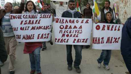 Click on image to see full-sized version Eva Nováková (holding placard) doing her stuff in the Bil'in demonstration