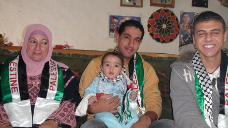 Thaer Hamad's mother; Rahma with her son Akram holding his own son, Thaer