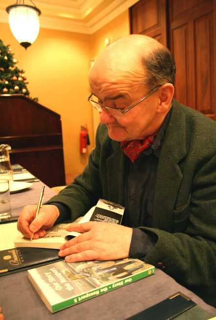 Click on image to see full-sized version Micheál Ó Seighin signs a copy of 'Our Story - the Rossport Five'