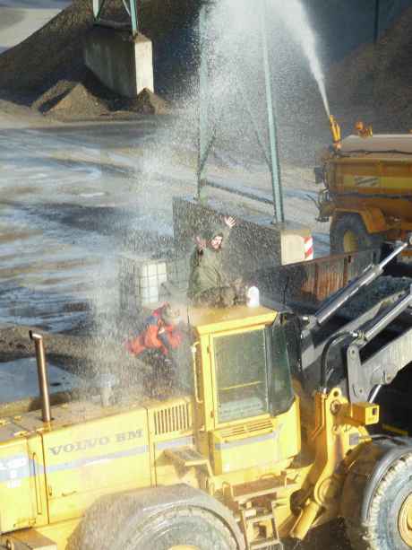 Click on image to see full-sized version Campaigners being water cannoned on top of the digger and truck