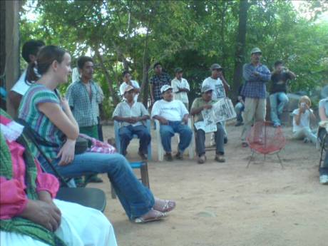 Click on image to see full-sized version OPIM men at the meeting in their headquarters, Jane Jones from Tlachinollan in the foreground and two Peace Brigades accompaniers who are delegated to OPIM on the far right